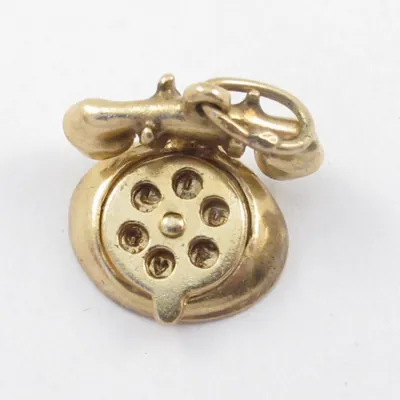 A vintage 14k gold rotary phone charm